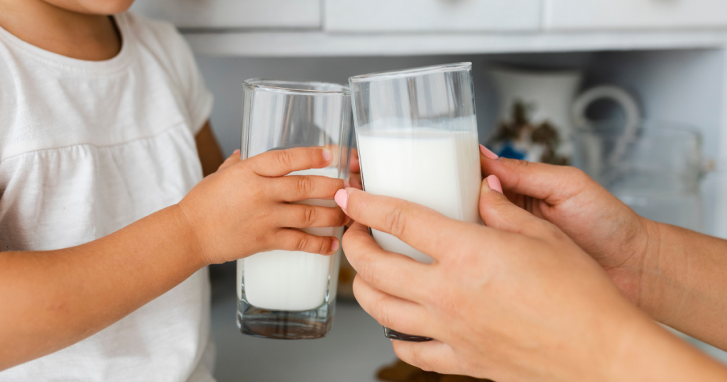 mãe e filha segurando copos de leite intolerância à lactose alergia à proteína do leite